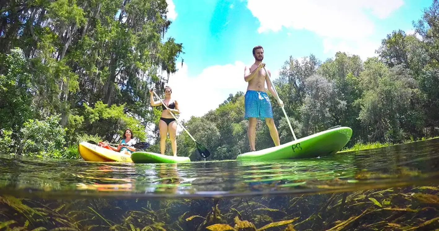 Two people kayaking down river